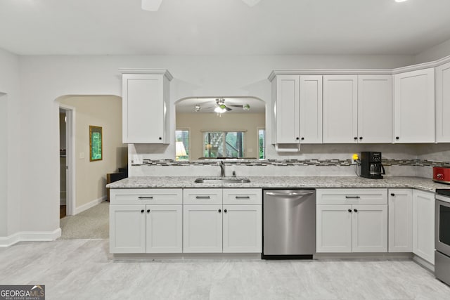 281 Hightower Lake Trl, Ball Ground, GA 30107 - kitchen with appliances with stainless steel finishes, ceiling fan, white cabinets, arched walkways, and light stone countertops