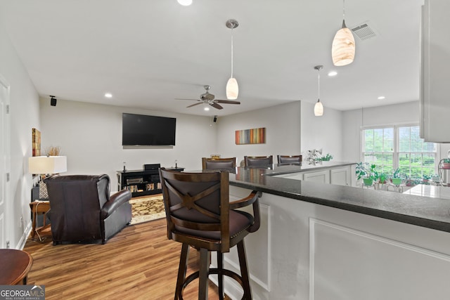 281 Hightower Lake Trl, Ball Ground, GA 30107 - kitchen featuring light wood finished floors, dark countertops, recessed lighting, decorative light fixtures, and a ceiling fan