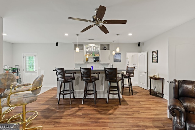 281 Hightower Lake Trl, Ball Ground, GA 30107 - kitchen with a kitchen bar, recessed lighting, ceiling fan, white cabinets, and hanging light fixtures