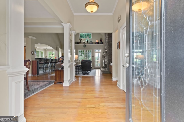 281 Hightower Lake Trl, Ball Ground, GA 30107 - foyer entrance with decorative columns, light wood-style floors, arched walkways, ornamental molding, and a high ceiling