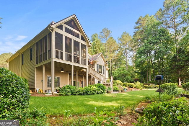 281 Hightower Lake Trl, Ball Ground, GA 30107 - rear view of house with ceiling fan, a sunroom, a yard, and stairs