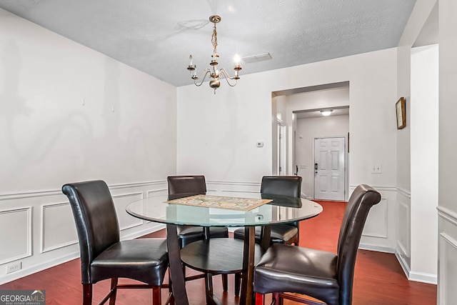 2555 Flat Shoals Rd Apt 2006, South Fulton, GA 30349 - dining room with a chandelier, dark wood-type flooring, a decorative wall, and a wainscoted wall