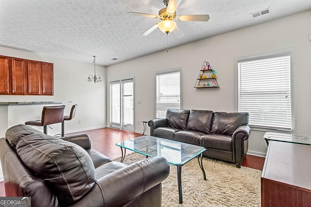 2555 Flat Shoals Rd Apt 2006, South Fulton, GA 30349 - living area featuring wood finished floors, a textured ceiling, and ceiling fan