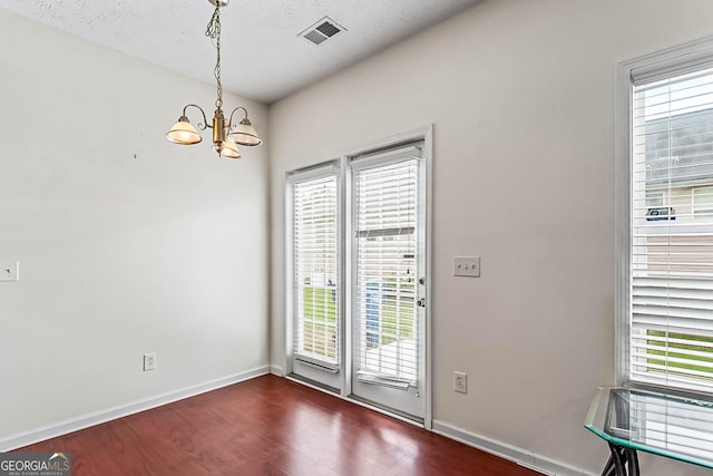 2555 Flat Shoals Rd Apt 2006, South Fulton, GA 30349 - unfurnished dining area featuring a chandelier, dark wood-style floors, and plenty of natural light