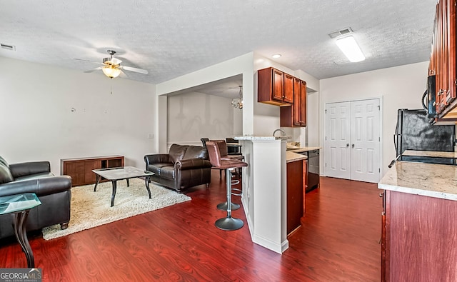 2555 Flat Shoals Rd Apt 2006, South Fulton, GA 30349 - living area with dark wood-style floors, a ceiling fan, and a textured ceiling