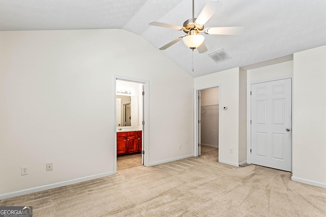 2555 Flat Shoals Rd Apt 2006, South Fulton, GA 30349 - unfurnished bedroom with vaulted ceiling, light carpet, a walk in closet, connected bathroom, and a closet