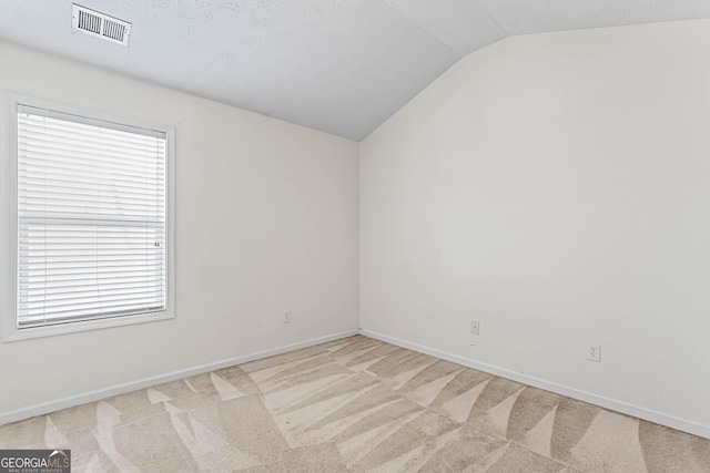2555 Flat Shoals Rd Apt 2006, South Fulton, GA 30349 - unfurnished room with vaulted ceiling and light carpet
