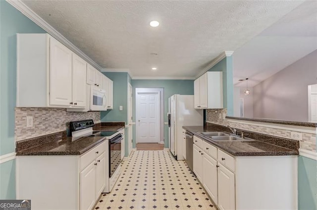 738 Baskins, Winder, GA 30680 - kitchen with white appliances, white cabinetry, tasteful backsplash, ornamental molding, and light floors