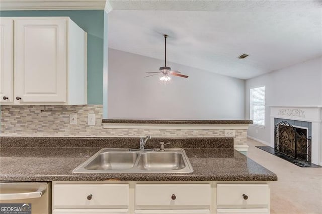738 Baskins, Winder, GA 30680 - kitchen featuring dark countertops, stainless steel dishwasher, a ceiling fan, and a fireplace