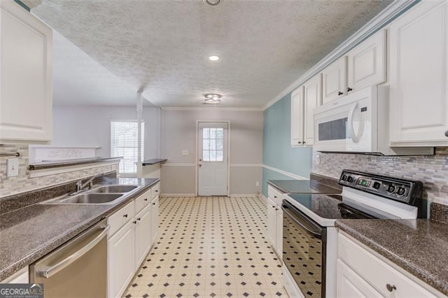 738 Baskins, Winder, GA 30680 - kitchen featuring electric range oven, white microwave, dishwasher, light floors, and dark countertops