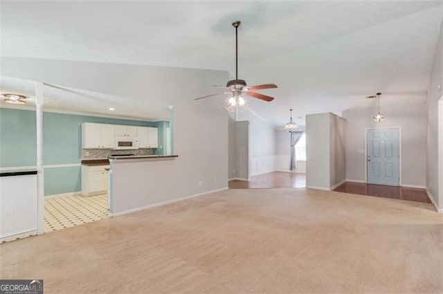 738 Baskins, Winder, GA 30680 - unfurnished living room with light carpet, a ceiling fan, vaulted ceiling, and recessed lighting