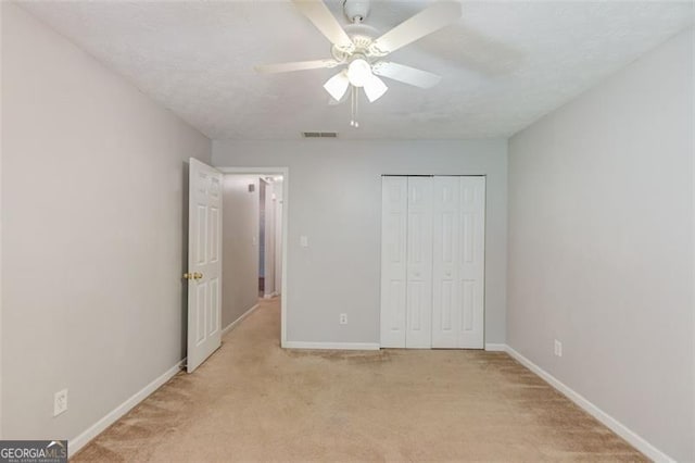 738 Baskins, Winder, GA 30680 - unfurnished bedroom with light carpet, a closet, and ceiling fan