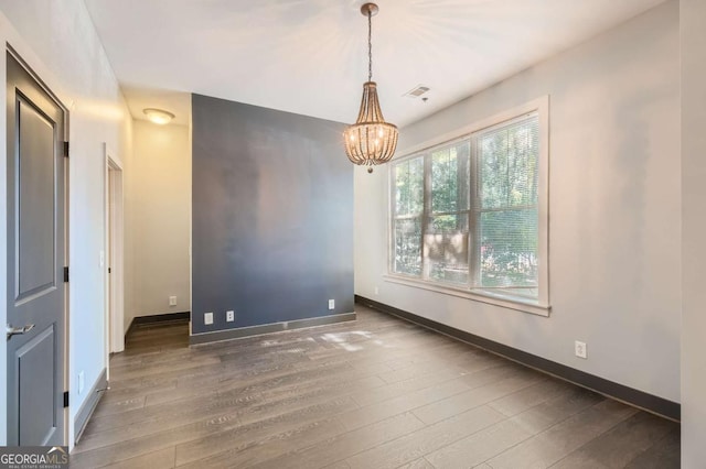 1195 Milton Ter Unit 5204, Atlanta, GA 30315 - spare room with wood finished floors and a chandelier