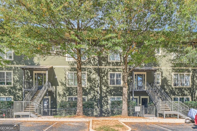1195 Milton Ter Unit 5204, Atlanta, GA 30315 - view of building exterior with stairway and uncovered parking