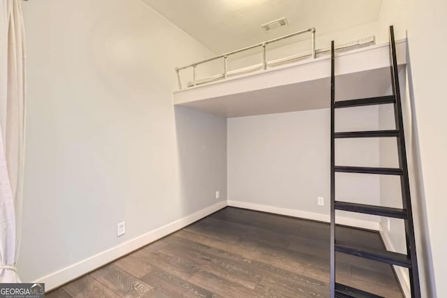 1195 Milton Ter Unit 5204, Atlanta, GA 30315 - unfurnished bedroom featuring baseboards and dark wood-style flooring