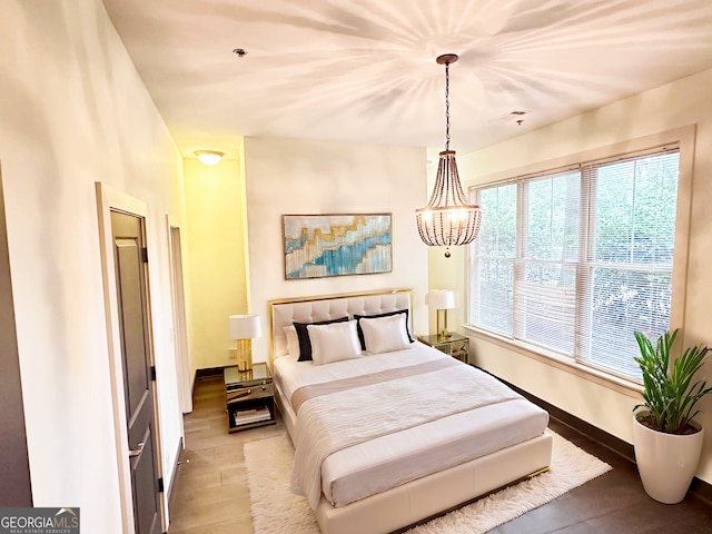 1195 Milton Ter Unit 5204, Atlanta, GA 30315 - bedroom featuring light wood-style floors and a chandelier