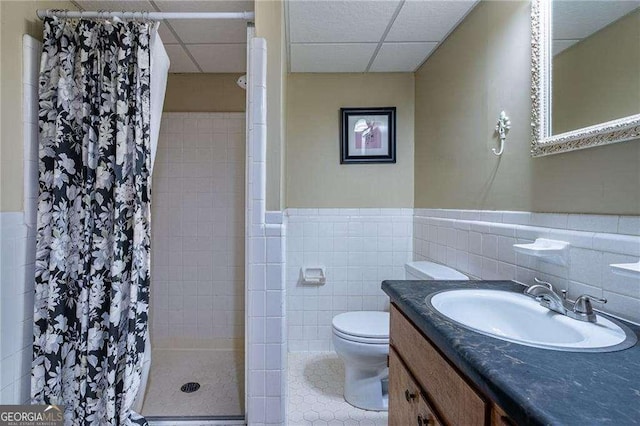 3300 Wiltshire Dr, Avondale Estates, GA 30002 - full bathroom featuring a paneled ceiling, a stall shower, vanity, tile walls, and wainscoting
