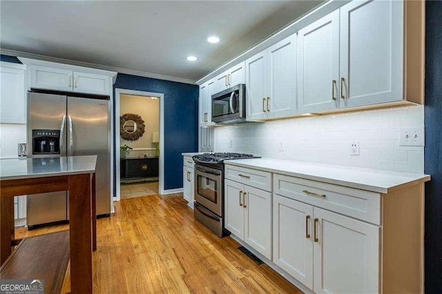 3300 Wiltshire Dr, Avondale Estates, GA 30002 - kitchen with appliances with stainless steel finishes, backsplash, light countertops, white cabinetry, and recessed lighting