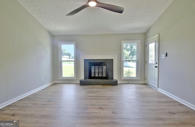 110 Chesterfield Ct, Fayetteville, GA 30214 - unfurnished living room with a textured ceiling, wood finished floors, a brick fireplace, and a ceiling fan