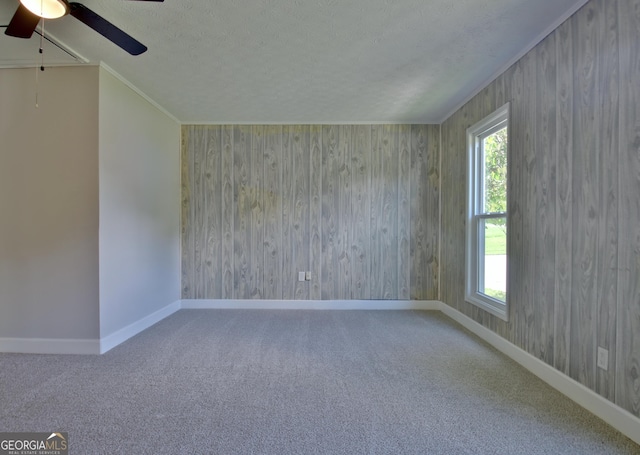 110 Chesterfield Ct, Fayetteville, GA 30214 - spare room featuring ceiling fan, a textured ceiling, carpet flooring, wood walls, and crown molding