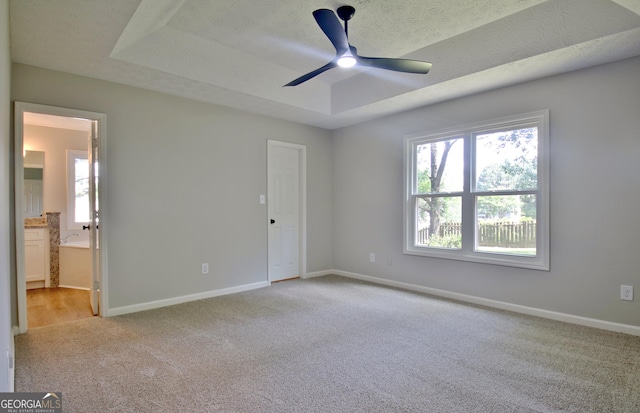 110 Chesterfield Ct, Fayetteville, GA 30214 - unfurnished bedroom with carpet floors, a raised ceiling, connected bathroom, and ceiling fan