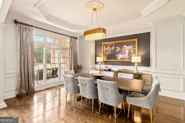 2230 Cambridge Hill Ct, Dacula, GA 30019 - dining room with a decorative wall, ornamental molding, a chandelier, wood finished floors, and a raised ceiling