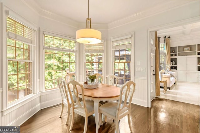 2230 Cambridge Hill Ct, Dacula, GA 30019 - dining area with crown molding, wood finished floors, built in features, and a wainscoted wall