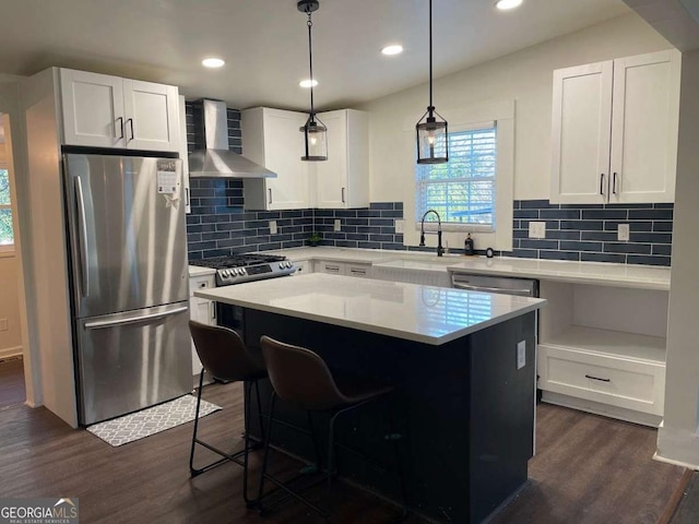 535 Walnut St, Hapeville, GA 30354 - kitchen with freestanding refrigerator, wall chimney range hood, dark wood-type flooring, decorative backsplash, and white cabinets