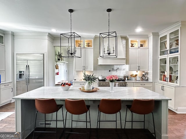 7093 Vaughn Rd, Canton, GA 30115 - kitchen with stainless steel built in fridge, stove, white cabinets, decorative backsplash, and crown molding