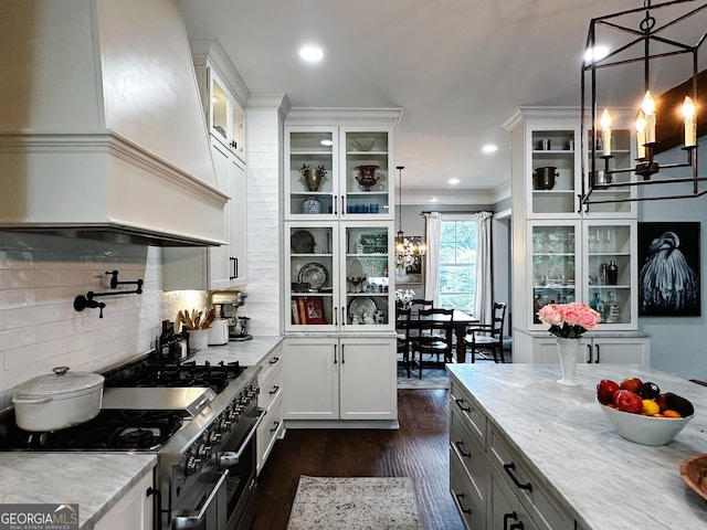 7093 Vaughn Rd, Canton, GA 30115 - kitchen featuring custom exhaust hood, range with two ovens, dark wood-type flooring, tasteful backsplash, and hanging light fixtures