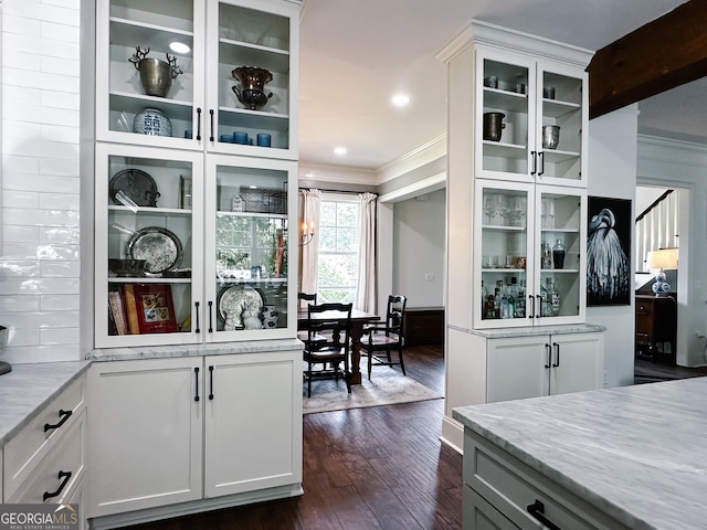 7093 Vaughn Rd, Canton, GA 30115 - kitchen with crown molding, dark wood-type flooring, glass insert cabinets, white cabinets, and light stone counters