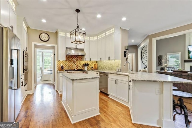 121 Fairway Overlook, Woodstock, GA 30188 - kitchen with stainless steel appliances, a peninsula, white cabinetry, decorative backsplash, and ornamental molding