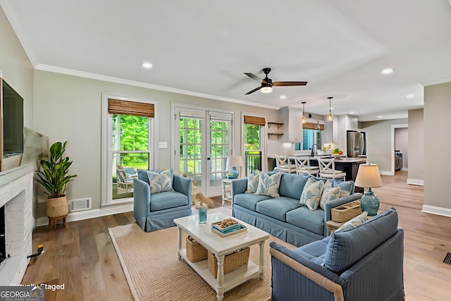 115 Edgewater Way, Peachtree City, GA 30269 - living room with crown molding, ceiling fan, light wood finished floors, a fireplace, and recessed lighting