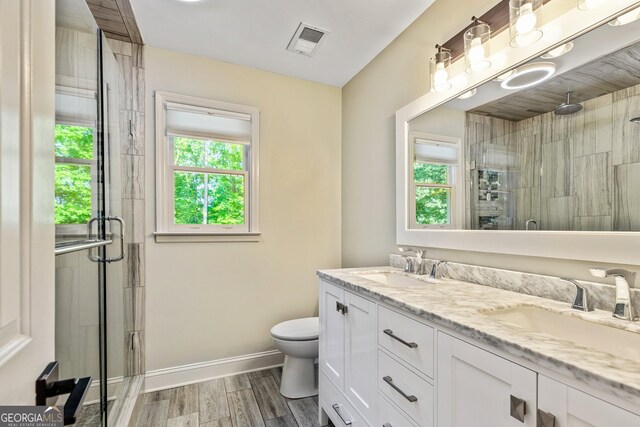 115 Edgewater Way, Peachtree City, GA 30269 - bathroom with a stall shower, double vanity, and wood finished floors