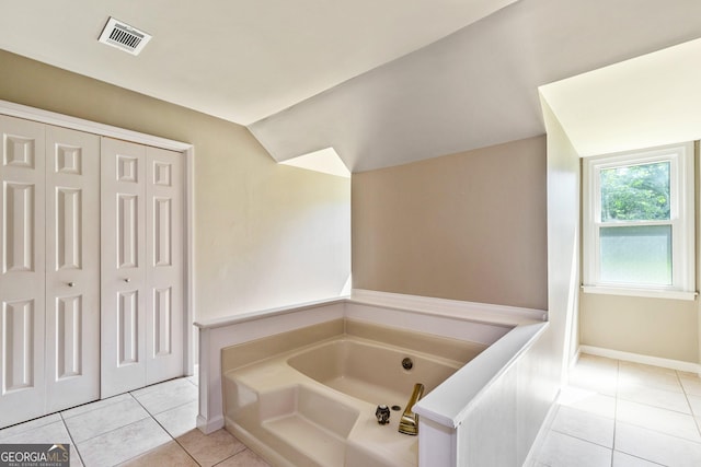 115 Edgewater Way, Peachtree City, GA 30269 - bathroom featuring a bath, tile patterned floors, a closet, and lofted ceiling