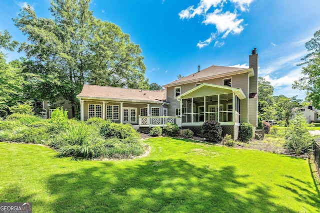 115 Edgewater Way, Peachtree City, GA 30269 - rear view of house featuring a sunroom, a chimney, and a deck