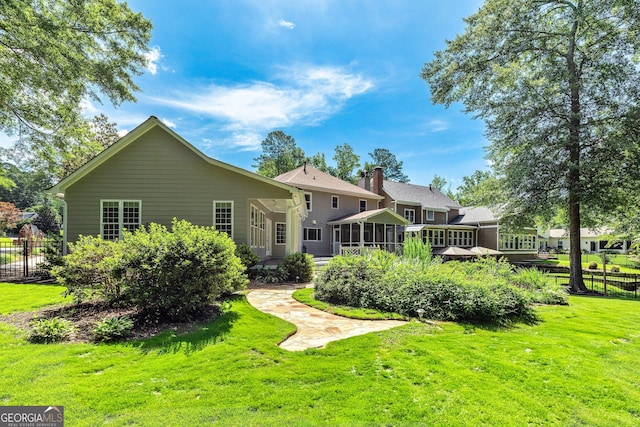 115 Edgewater Way, Peachtree City, GA 30269 - rear view of property featuring a sunroom and a chimney