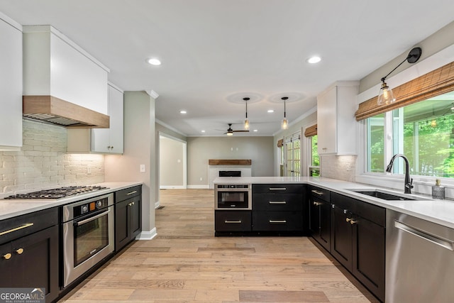 115 Edgewater Way, Peachtree City, GA 30269 - kitchen with stainless steel appliances, ceiling fan, custom exhaust hood, white cabinets, and recessed lighting