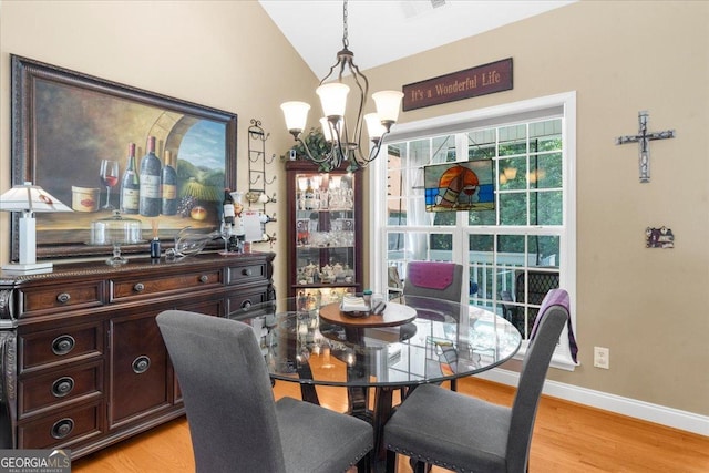 221 Timber Ridge Dr, Clarkesville, GA 30523 - dining room with a chandelier, light wood-type flooring, and lofted ceiling