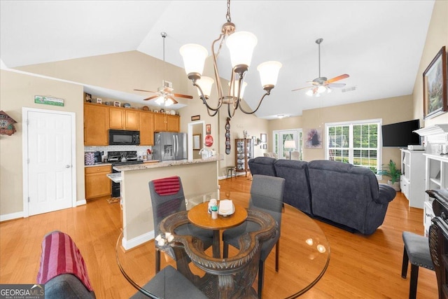 221 Timber Ridge Dr, Clarkesville, GA 30523 - dining area featuring ceiling fan, light wood-style floors, a chandelier, and high vaulted ceiling