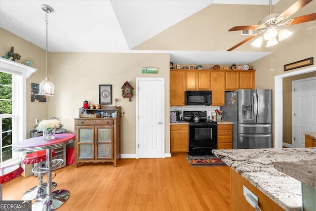221 Timber Ridge Dr, Clarkesville, GA 30523 - kitchen with black appliances, brown cabinets, light wood-style flooring, ceiling fan, and lofted ceiling