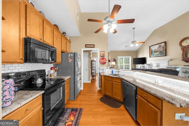 221 Timber Ridge Dr, Clarkesville, GA 30523 - kitchen with black appliances, open floor plan, light wood-style floors, backsplash, and a ceiling fan