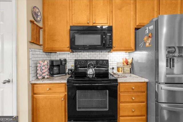 221 Timber Ridge Dr, Clarkesville, GA 30523 - kitchen featuring black appliances, tasteful backsplash, light stone counters, and brown cabinets