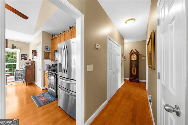 221 Timber Ridge Dr, Clarkesville, GA 30523 - kitchen featuring stainless steel appliances, light wood-type flooring, brown cabinetry, and tasteful backsplash