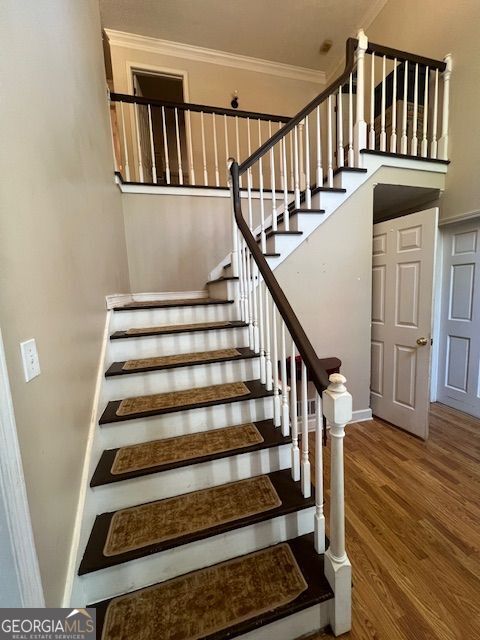 974 Bloomfield Dr, Lawrenceville, GA 30044 - staircase featuring crown molding and wood finished floors