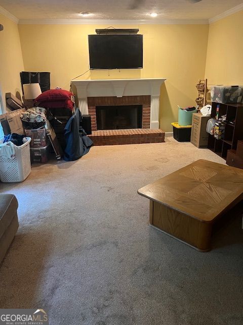 974 Bloomfield Dr, Lawrenceville, GA 30044 - living room featuring crown molding, carpet flooring, and a fireplace