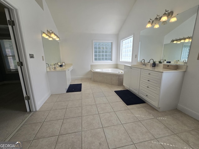 176 Fairoaks Cir, Stockbridge, GA 30281 - full bathroom with tile patterned flooring, a bath, two vanities, and high vaulted ceiling
