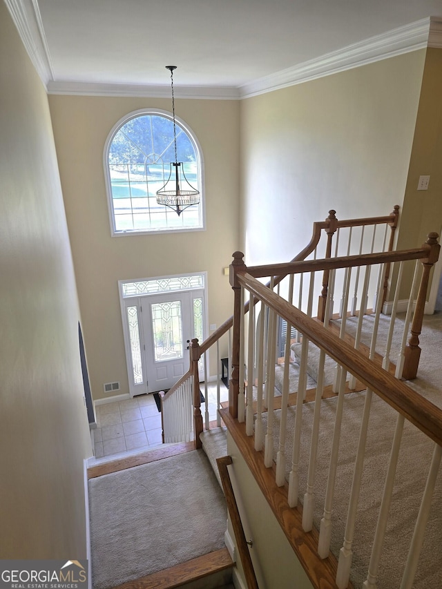 176 Fairoaks Cir, Stockbridge, GA 30281 - tiled foyer with healthy amount of natural light, crown molding, and a chandelier