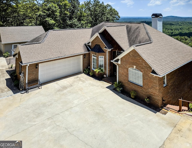 865 Laurel Ridge Rd, Cleveland, GA 30528 - view of front of home with brick siding, concrete driveway, a garage, and a chimney