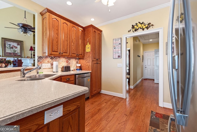 865 Laurel Ridge Rd, Cleveland, GA 30528 - kitchen featuring stainless steel appliances, ceiling fan, decorative backsplash, brown cabinets, and ornamental molding